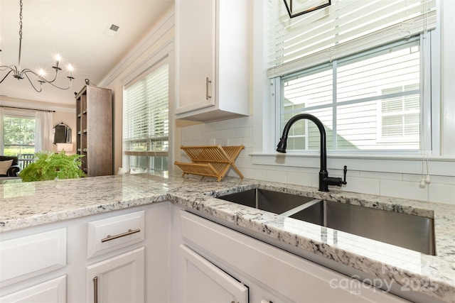 7344 Gilead Rd, Huntersville, NC 28078 - kitchen with tasteful backsplash, white cabinetry, a chandelier, and decorative light fixtures