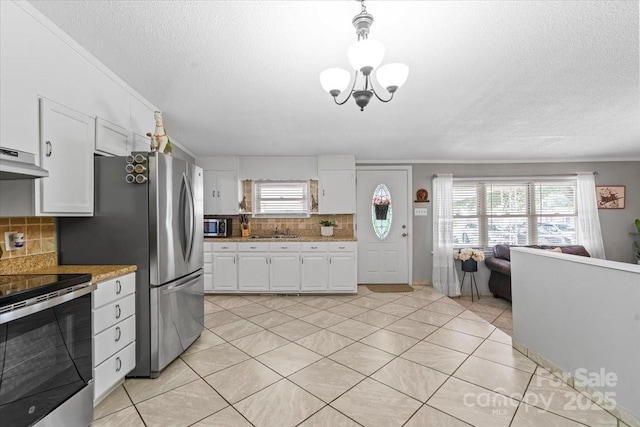 1627 33rd Ave NE, Hickory, NC 28601 - kitchen with appliances with stainless steel finishes, backsplash, white cabinetry, a textured ceiling, and open floor plan