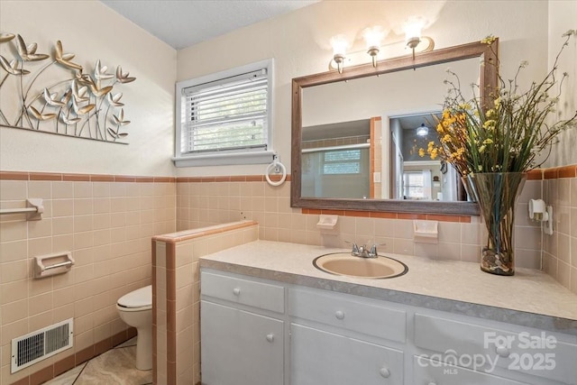 1627 33rd Ave NE, Hickory, NC 28601 - bathroom featuring vanity, tile walls, and wainscoting