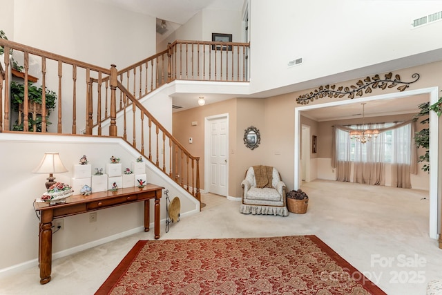 8701 Appaloosa Way Ln, Charlotte, NC 28216 - carpeted foyer with a chandelier, stairs, and a towering ceiling