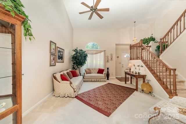 8701 Appaloosa Way Ln, Charlotte, NC 28216 - carpeted living room featuring high vaulted ceiling, stairs, and ceiling fan