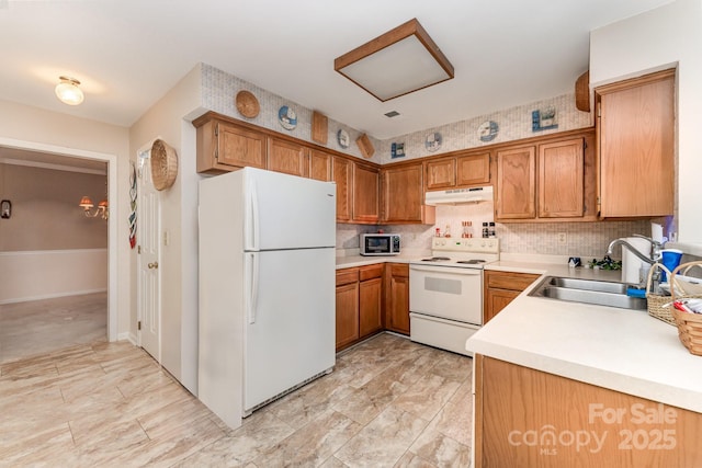 8701 Appaloosa Way Ln, Charlotte, NC 28216 - kitchen featuring white appliances, under cabinet range hood, light countertops, and decorative backsplash