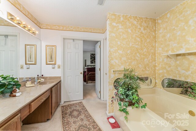 8701 Appaloosa Way Ln, Charlotte, NC 28216 - bathroom with vanity, a tub, and wallpapered walls