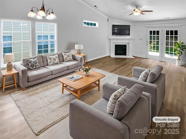 2010 Kansas City Dr, Monroe, NC 28110 - living room with vaulted ceiling, wood finished floors, a chandelier, a ceiling fan, and a fireplace with flush hearth