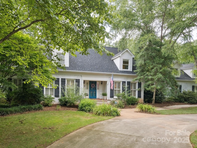 2032 Greenbrook Pkwy, Matthews, NC 28104 - cape cod home with a shingled roof, a front yard, and brick siding