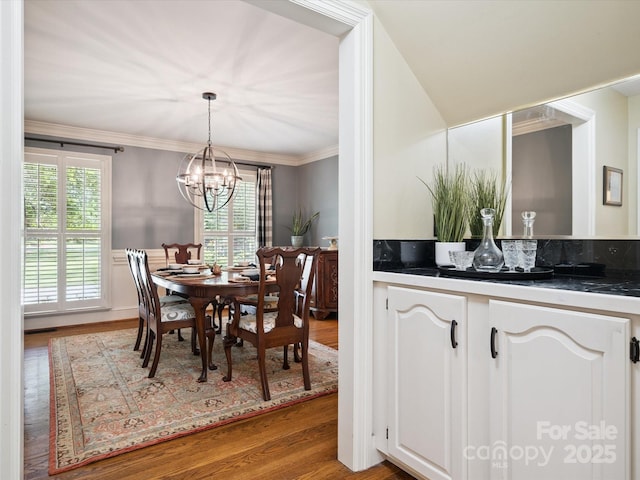 2032 Greenbrook Pkwy, Matthews, NC 28104 - dining area with wood finished floors, a chandelier, and crown molding
