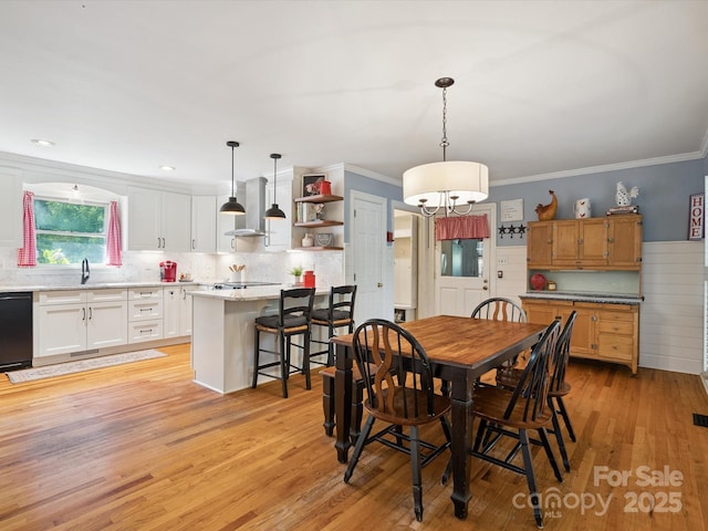 2032 Greenbrook Pkwy, Matthews, NC 28104 - dining room with light wood-style flooring, ornamental molding, and a chandelier