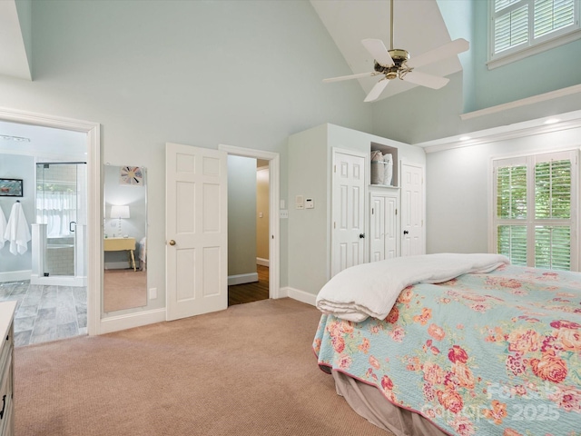 2032 Greenbrook Pkwy, Matthews, NC 28104 - carpeted bedroom featuring high vaulted ceiling, multiple windows, ensuite bath, and a ceiling fan