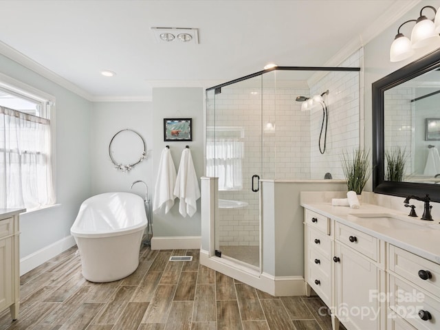 2032 Greenbrook Pkwy, Matthews, NC 28104 - bathroom featuring vanity, ornamental molding, a freestanding tub, a stall shower, and wood tiled floors