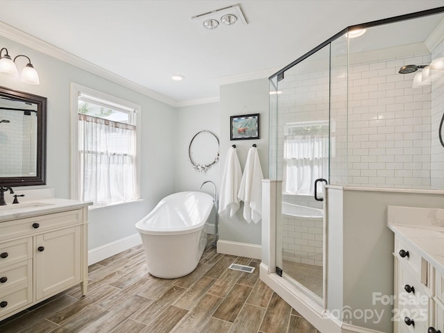 2032 Greenbrook Pkwy, Matthews, NC 28104 - bathroom featuring vanity, crown molding, a shower stall, a soaking tub, and wood finished floors