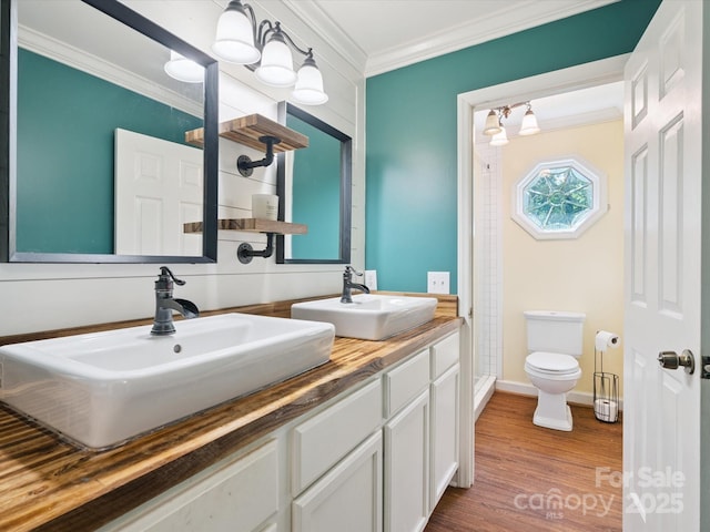 2032 Greenbrook Pkwy, Matthews, NC 28104 - bathroom featuring ornamental molding, a stall shower, double vanity, and wood finished floors