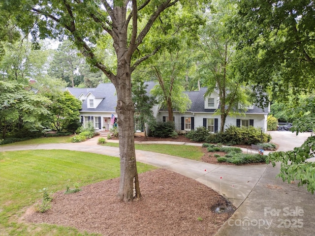 2032 Greenbrook Pkwy, Matthews, NC 28104 - cape cod house featuring a front lawn and curved driveway