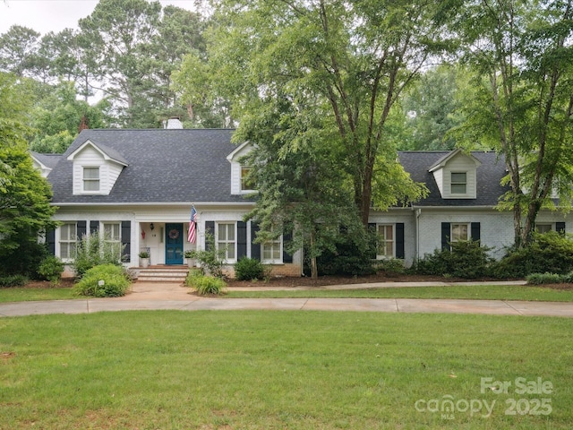2032 Greenbrook Pkwy, Matthews, NC 28104 - new england style home featuring a front lawn, roof with shingles, brick siding, and a chimney