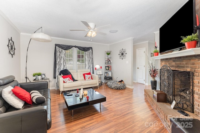 713 Hickory Hill Ct, Gastonia, NC 28054 - living room featuring a ceiling fan, ornamental molding, a brick fireplace, wood finished floors, and a textured ceiling