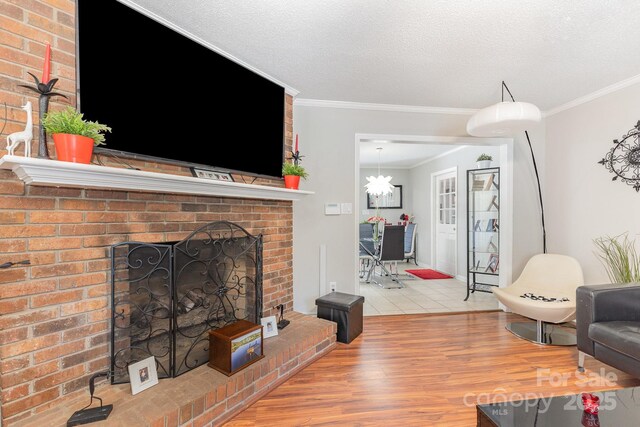 713 Hickory Hill Ct, Gastonia, NC 28054 - living area with a fireplace, wood finished floors, ornamental molding, and a textured ceiling
