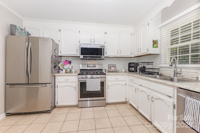 713 Hickory Hill Ct, Gastonia, NC 28054 - kitchen featuring stainless steel appliances, crown molding, white cabinetry, tasteful backsplash, and light countertops