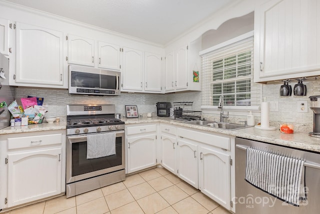 713 Hickory Hill Ct, Gastonia, NC 28054 - kitchen featuring stainless steel appliances, light tile patterned floors, tasteful backsplash, white cabinetry, and light stone countertops
