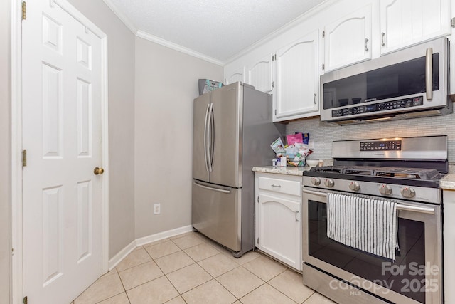 713 Hickory Hill Ct, Gastonia, NC 28054 - kitchen featuring stainless steel appliances, ornamental molding, decorative backsplash, white cabinetry, and light tile patterned floors