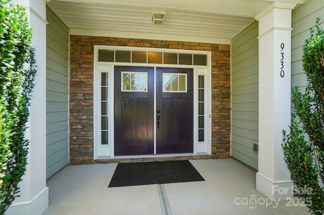 9330 Carneros Creek Rd, Charlotte, NC 28214 - doorway to property with stone siding and covered porch