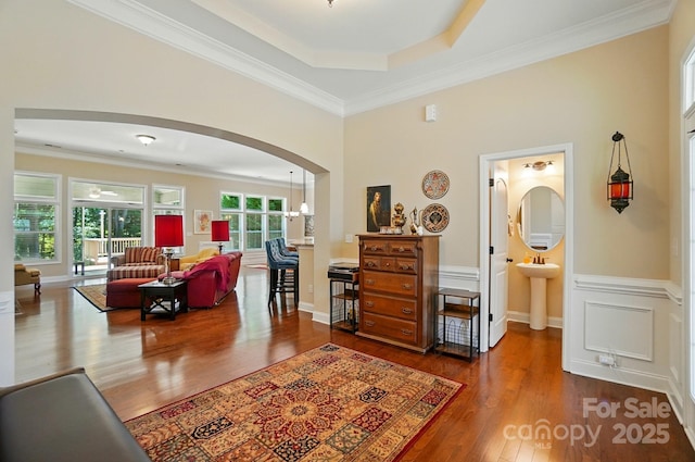 9330 Carneros Creek Rd, Charlotte, NC 28214 - living room with arched walkways, wood finished floors, and ornamental molding