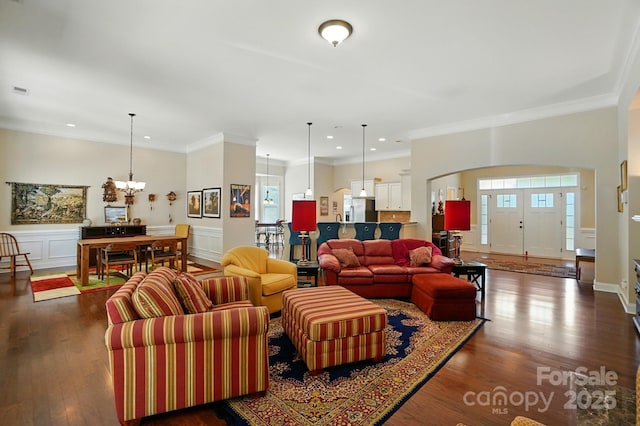 9330 Carneros Creek Rd, Charlotte, NC 28214 - living area featuring a chandelier, arched walkways, dark wood-type flooring, recessed lighting, and ornamental molding