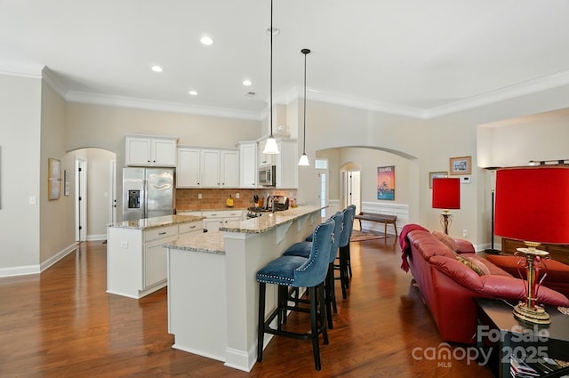 9330 Carneros Creek Rd, Charlotte, NC 28214 - kitchen featuring stainless steel appliances, arched walkways, crown molding, white cabinets, and a peninsula