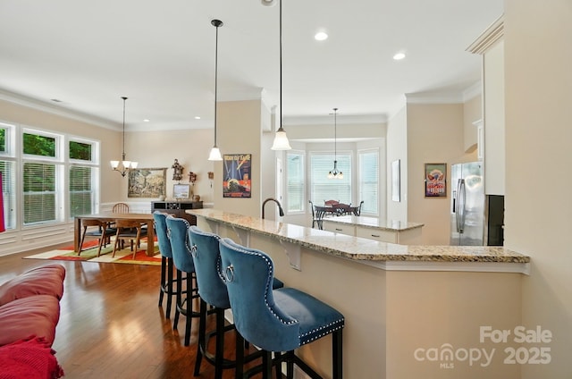 9330 Carneros Creek Rd, Charlotte, NC 28214 - kitchen with stainless steel fridge with ice dispenser, a chandelier, crown molding, dark wood finished floors, and decorative light fixtures