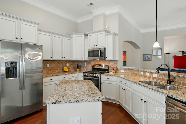 9330 Carneros Creek Rd, Charlotte, NC 28214 - kitchen featuring stainless steel appliances, ornamental molding, arched walkways, backsplash, and white cabinets