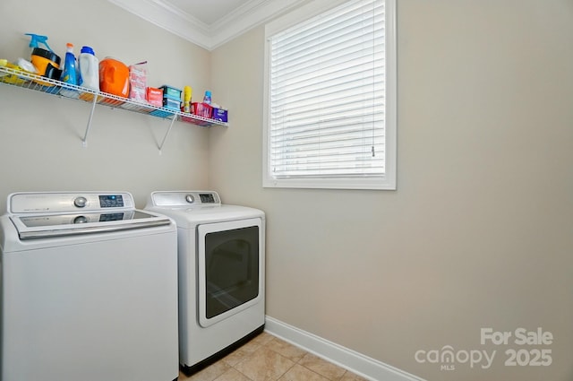 9330 Carneros Creek Rd, Charlotte, NC 28214 - laundry room with washing machine and clothes dryer, ornamental molding, and light tile patterned flooring