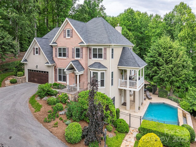 1 Hickory Rdg, Fletcher, NC 28732 - view of front of house with roof with shingles, a balcony, a chimney, a garage, and driveway