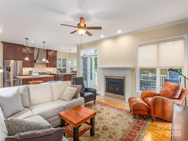 1 Hickory Rdg, Fletcher, NC 28732 - living room with a ceiling fan, ornamental molding, light wood-style flooring, a tile fireplace, and recessed lighting