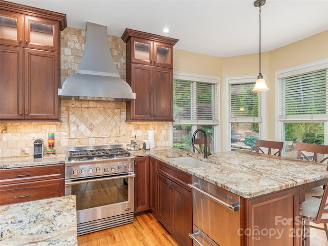 1 Hickory Rdg, Fletcher, NC 28732 - kitchen featuring appliances with stainless steel finishes, custom exhaust hood, a kitchen breakfast bar, a peninsula, and light wood-type flooring