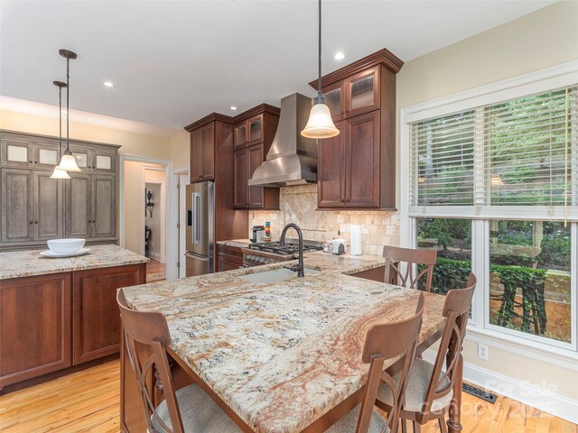 1 Hickory Rdg, Fletcher, NC 28732 - kitchen with wall chimney range hood, high quality fridge, decorative backsplash, light wood-style floors, and recessed lighting