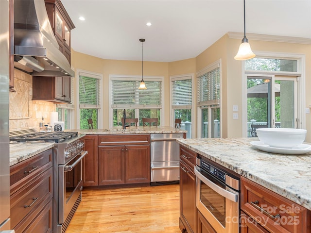 1 Hickory Rdg, Fletcher, NC 28732 - kitchen with wall chimney range hood, stainless steel appliances, light wood finished floors, recessed lighting, and light stone counters
