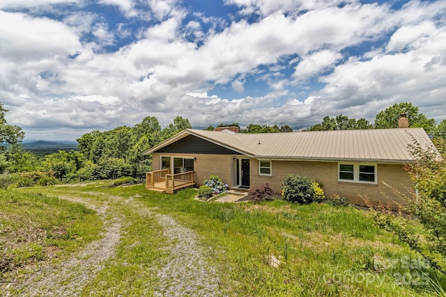 41 Remembrance Rdg, Flat Rock, NC 28731 - view of front of home featuring a chimney, brick siding, and a metal roof