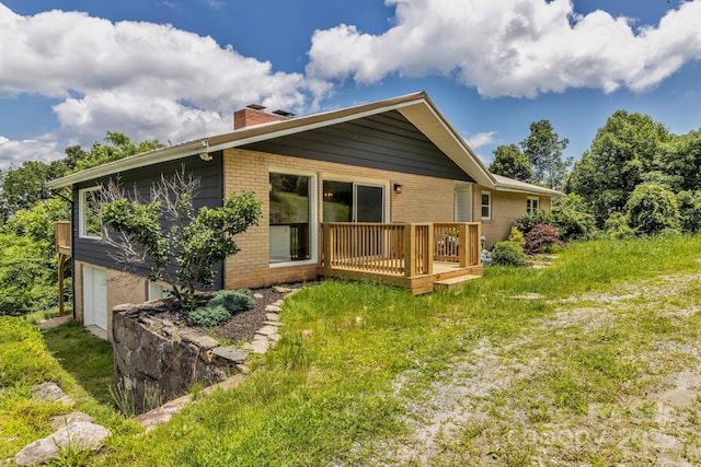 41 Remembrance Rdg, Flat Rock, NC 28731 - rear view of house featuring a chimney, brick siding, a wooden deck, and an attached garage