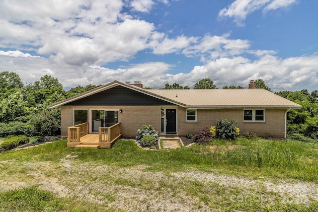 41 Remembrance Rdg, Flat Rock, NC 28731 - rear view of property featuring a chimney, brick siding, a wooden deck, and a metal roof