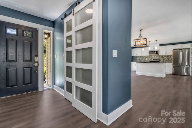 41 Remembrance Rdg, Flat Rock, NC 28731 - entrance foyer featuring dark wood-type flooring, a chandelier, and a barn door