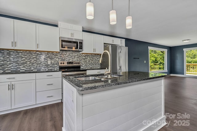 41 Remembrance Rdg, Flat Rock, NC 28731 - kitchen featuring appliances with stainless steel finishes, dark wood-style floors, backsplash, and a center island with sink