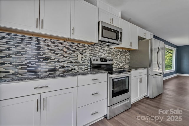 41 Remembrance Rdg, Flat Rock, NC 28731 - kitchen with stainless steel appliances, dark wood finished floors, white cabinets, and tasteful backsplash