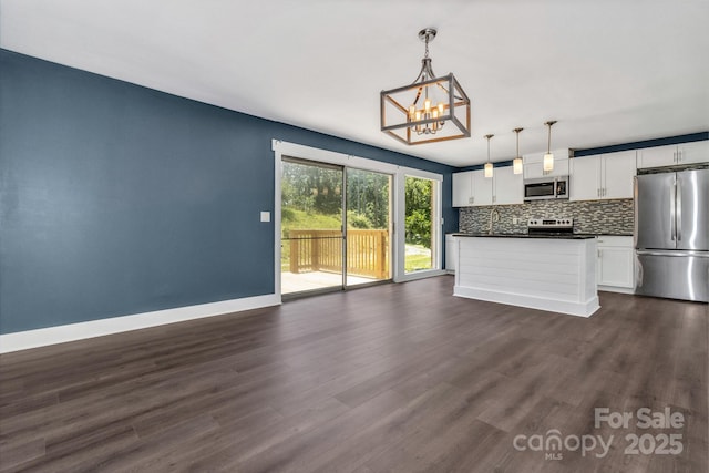41 Remembrance Rdg, Flat Rock, NC 28731 - unfurnished living room featuring a chandelier and dark wood-style flooring