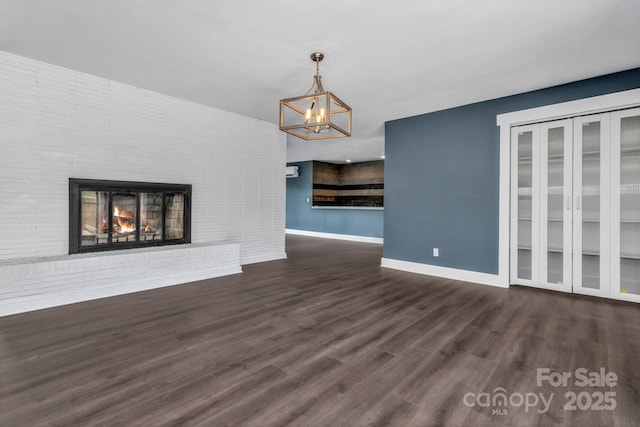 41 Remembrance Rdg, Flat Rock, NC 28731 - unfurnished living room featuring a chandelier, wood finished floors, and a fireplace