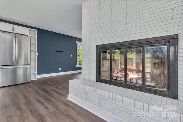 41 Remembrance Rdg, Flat Rock, NC 28731 - detailed view of freestanding refrigerator, a fireplace, dark wood-style floors, and white cabinetry