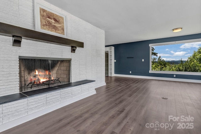 41 Remembrance Rdg, Flat Rock, NC 28731 - unfurnished living room with a brick fireplace and wood finished floors