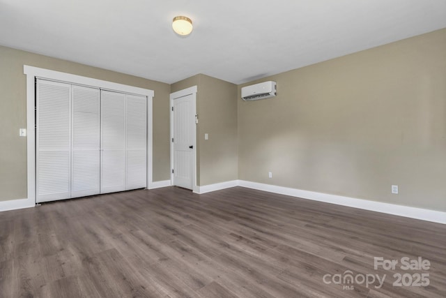 41 Remembrance Rdg, Flat Rock, NC 28731 - unfurnished bedroom featuring a wall mounted air conditioner, dark wood-style flooring, and a closet