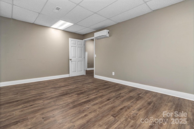 41 Remembrance Rdg, Flat Rock, NC 28731 - empty room with a drop ceiling, a wall mounted AC, and dark wood-type flooring