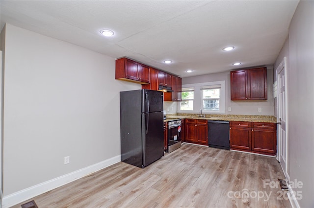 636 Forest St NW, Concord, NC 28025 - kitchen featuring black appliances, reddish brown cabinets, light wood-style flooring, and recessed lighting