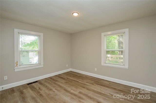 636 Forest St NW, Concord, NC 28025 - empty room with wood finished floors and baseboards