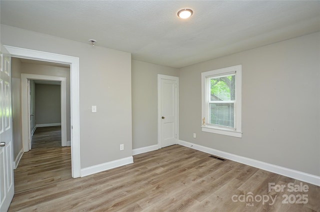 636 Forest St NW, Concord, NC 28025 - unfurnished bedroom with light wood-type flooring