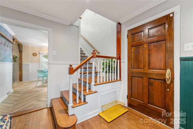 2034 Lanier Ave, Charlotte, NC 28205 - entryway with a wainscoted wall, stairs, parquet floors, and ornamental molding